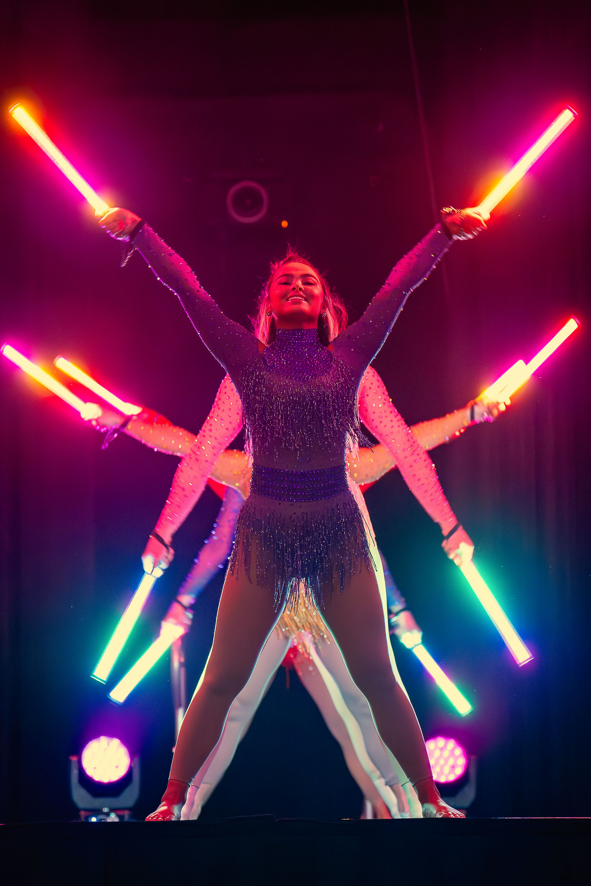 Aerialists pouring champagne from custom teardrop bars suspended 20 feet above the crowd, NYE Rio Carnival entertainment